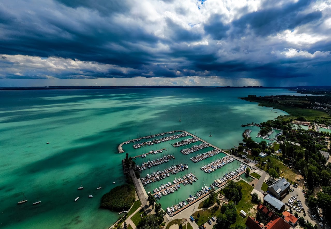 Kvízjáték - Ismerd fel! Balatoni települések - 3. kérdés: A képen a vihar a Balaton egyik legdrágább kikötője felett tombol. Hol található ez a megfizethetetlenül drága kikötő? - Alsóörs, Balatonfűzfő, Balatonmáriafürdő, Balatongyörök